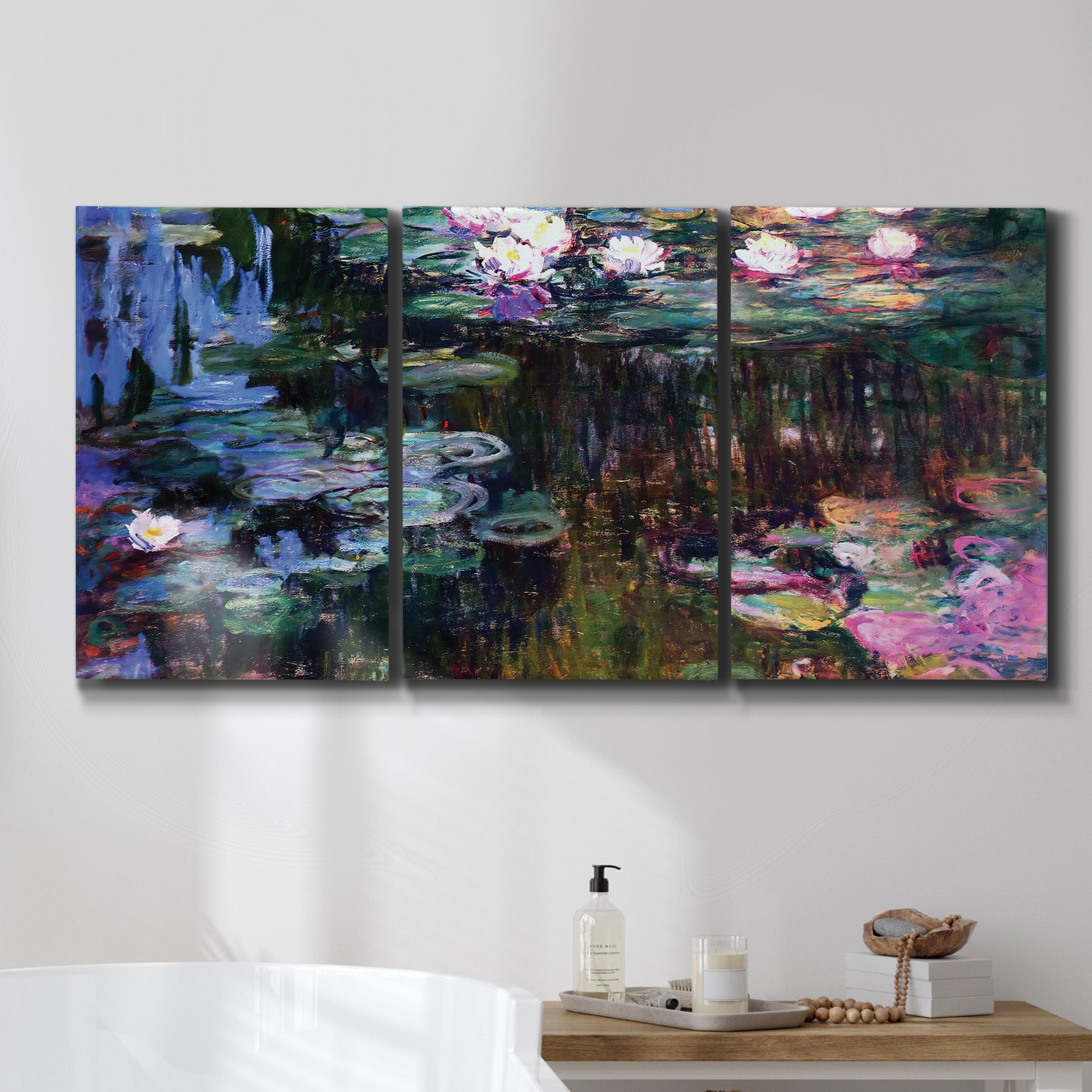 Three-panel canvas wall art featuring water lilies with willow reflections, displayed in a bathroom above a bathtub.