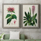 Set of two gray barnwood framed canvas prints depicting a coordinated art pair of colorful flowering plant specimens rendered as antique botanical plate illustrations above a sofa in a modern living room.