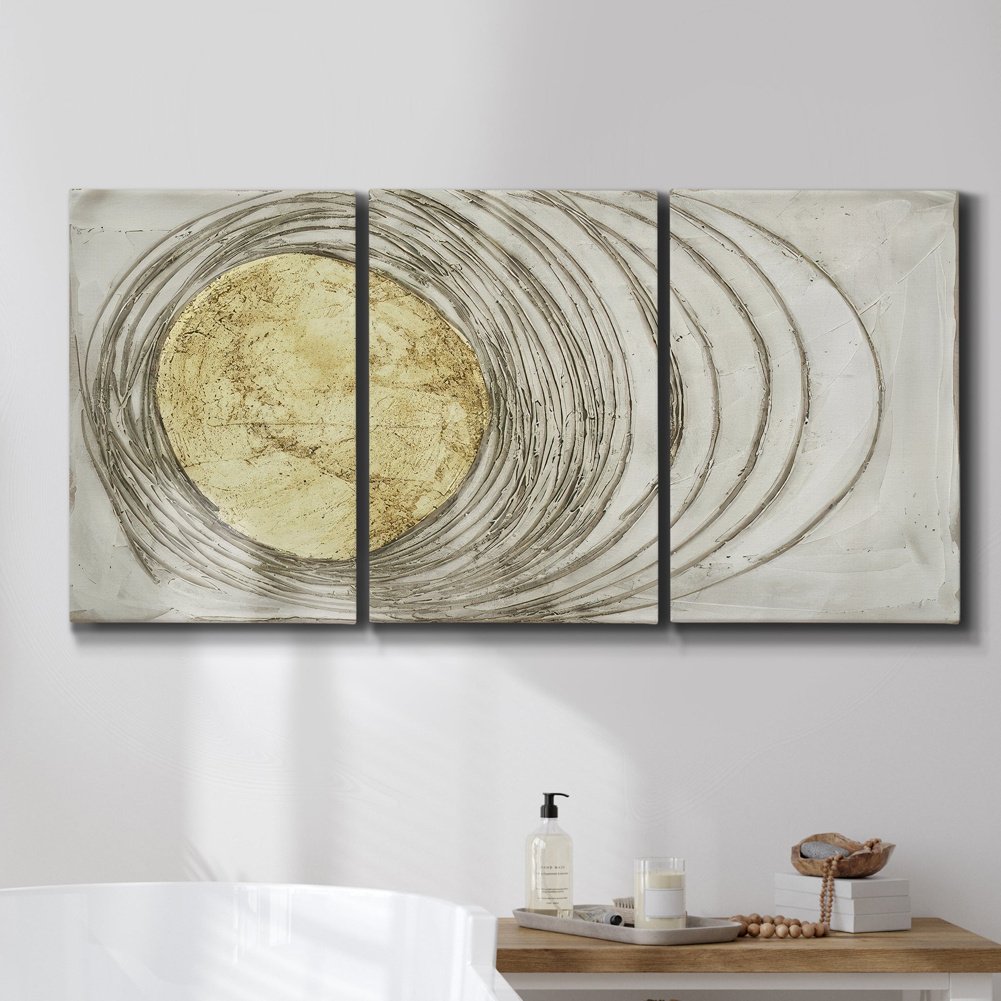 Three-panel canvas wall art featuring circular abstract energy forms, displayed in a bathroom above a bathtub.