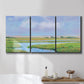 Three-panel canvas wall art featuring summer marshland with tall grasses, displayed in a bathroom above a bathtub.