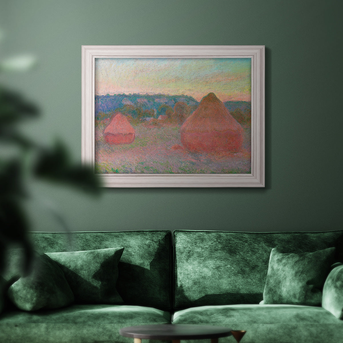 Impressionist haystack series landscape by Claude Monet in an ornate weathered white frame displayed in a dark-toned interior setting.