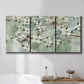 Three-panel canvas wall art featuring delicate spring blossoms with birds, displayed in a bathroom above a bathtub.