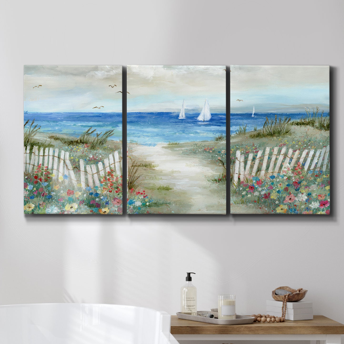 Three-panel canvas wall art featuring lush coastal garden landscape, displayed in a bathroom above a bathtub.