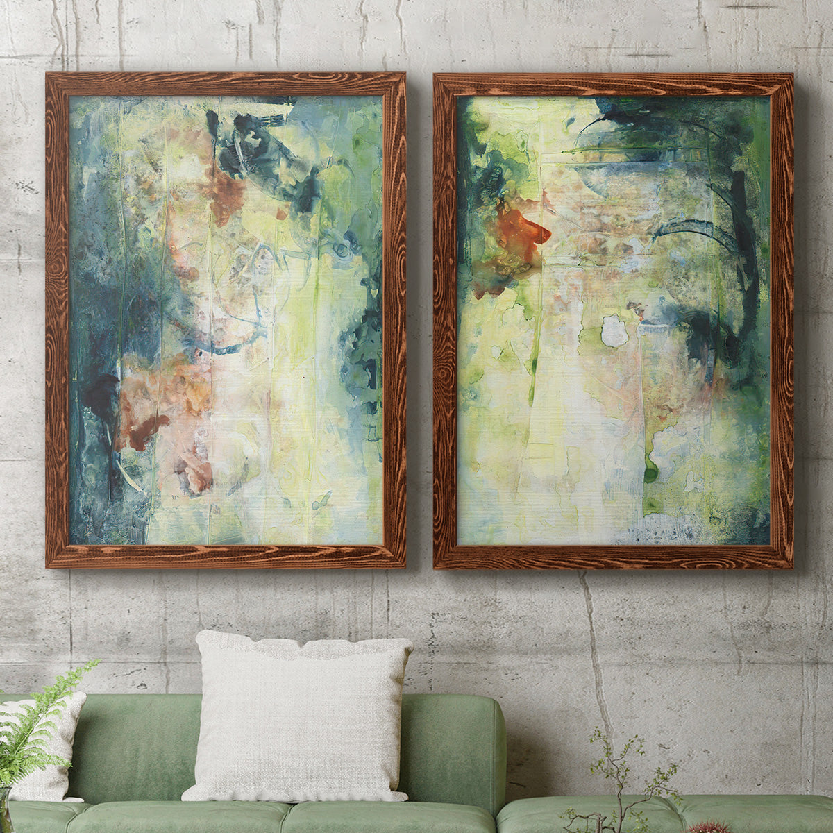 Set of two maple barnwood framed canvas prints depicting a coordinated art pair of layered blue green cream and charcoal textures rendered as nature-inspired mixed-media abstracts above a sofa in a modern living room.