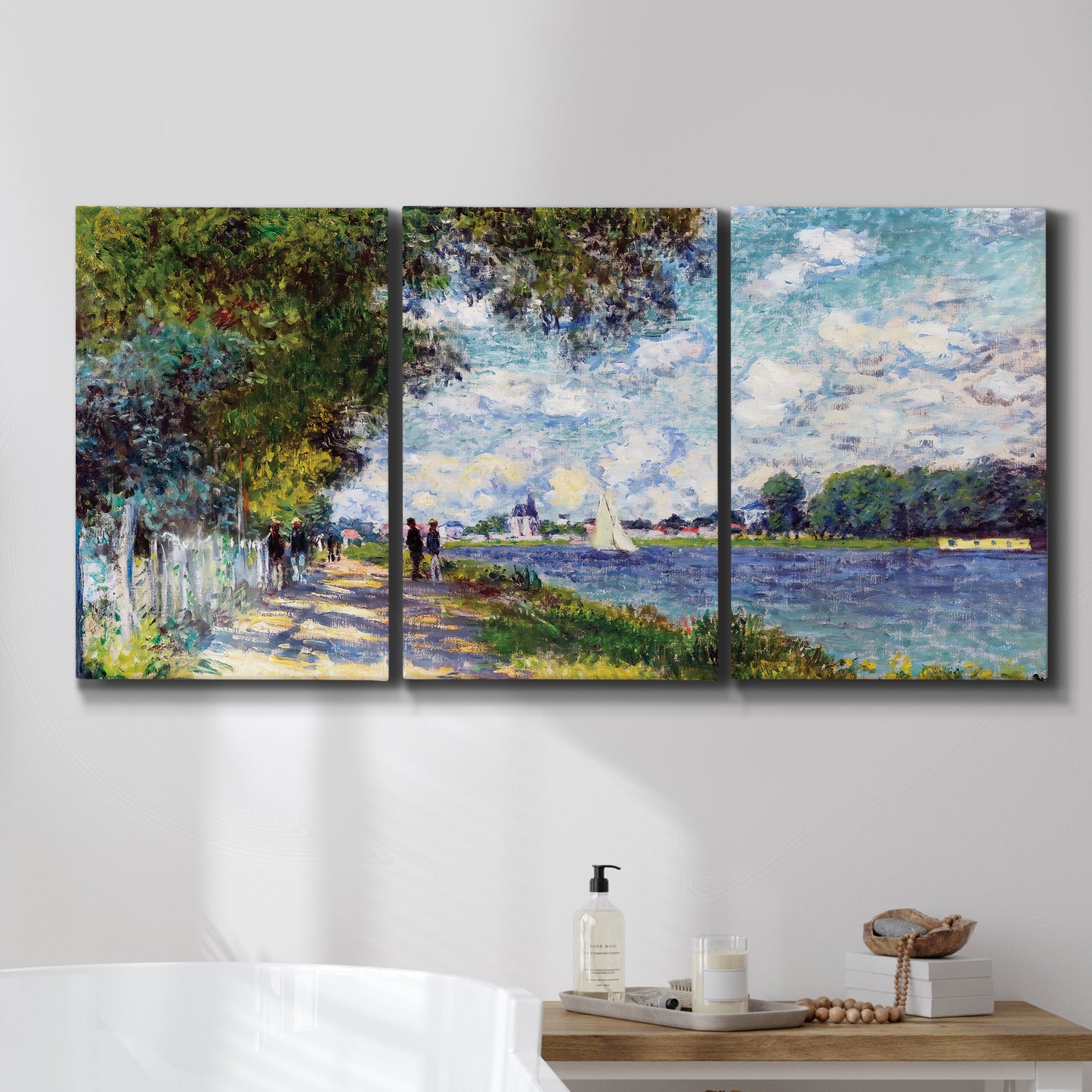 Three-panel canvas wall art featuring river landscape with boats, displayed in a bathroom above a bathtub.