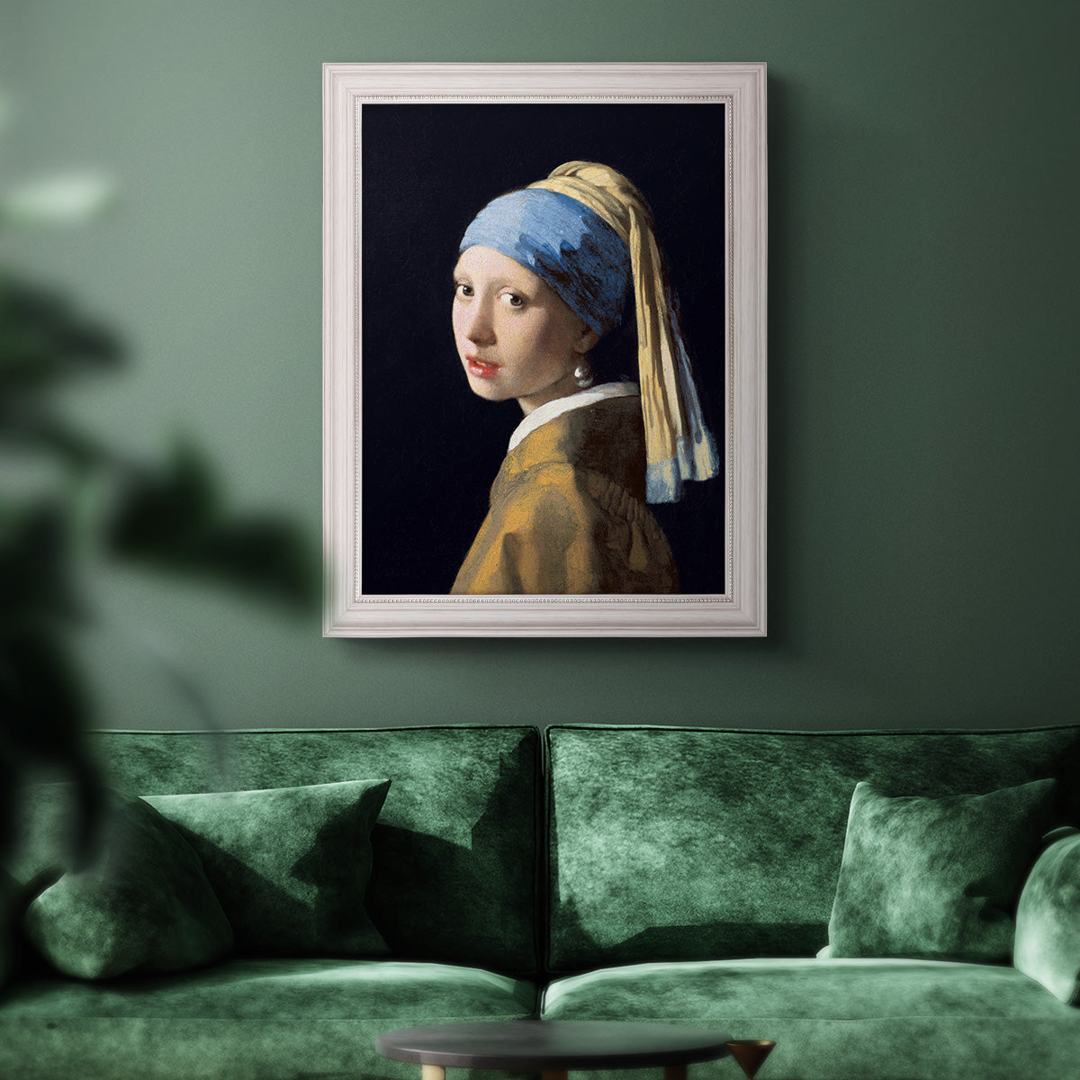 Iconic portrait of a girl wearing a pearl earring by Johannes Vermeer in an ornate weathered white frame displayed in a dark-toned interior setting.