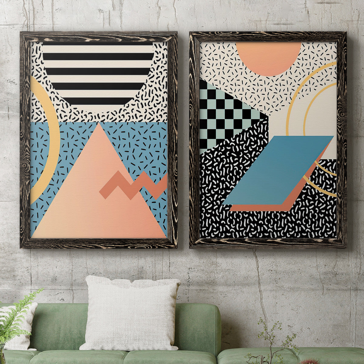 Set of two black barnwood framed canvas prints depicting a coordinated art pair of bold geometric Memphis-style patterns rendered as retro graphic abstracts above a sofa in a modern living room.