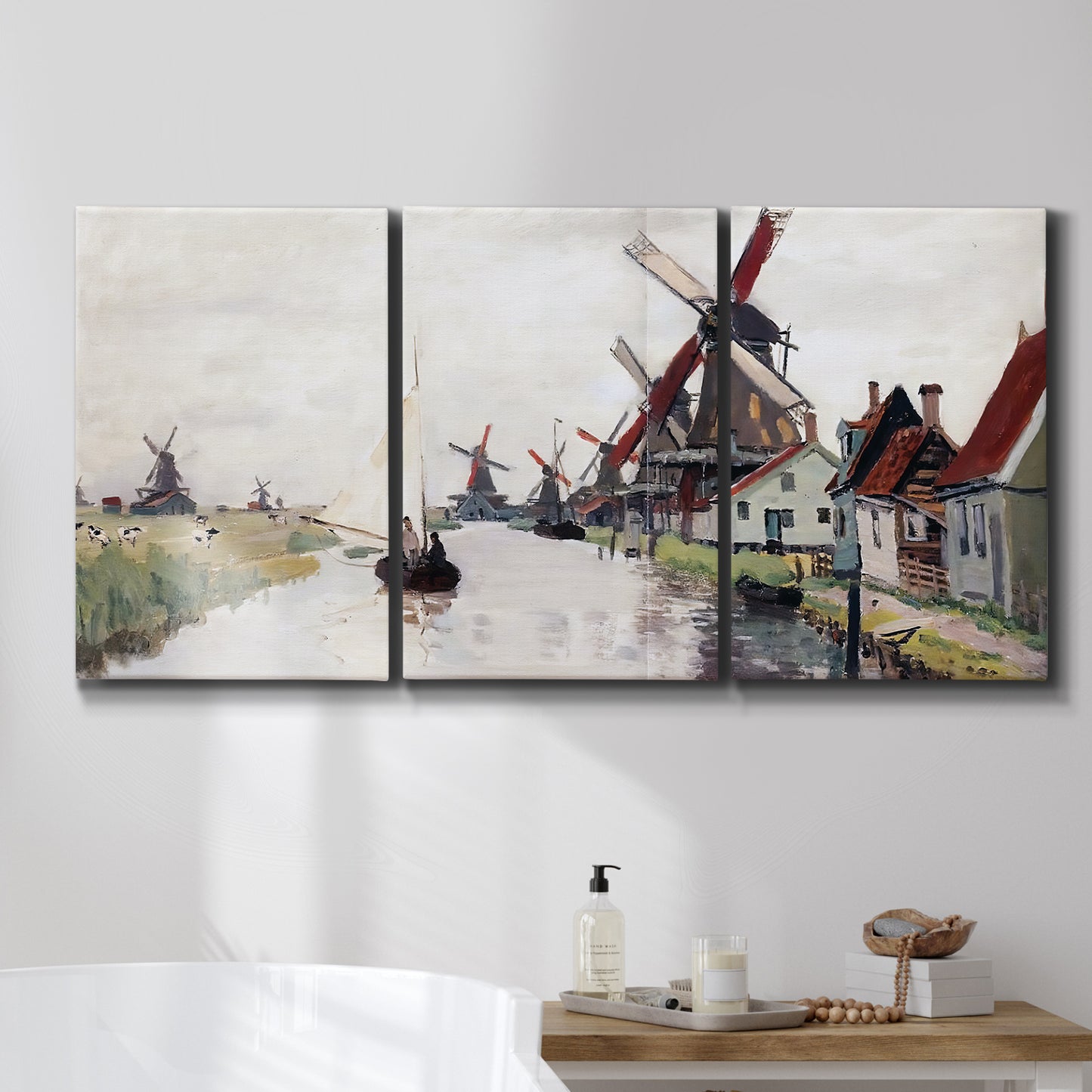 Three-panel canvas wall art featuring windmills beside calm water, displayed in a bathroom above a bathtub.