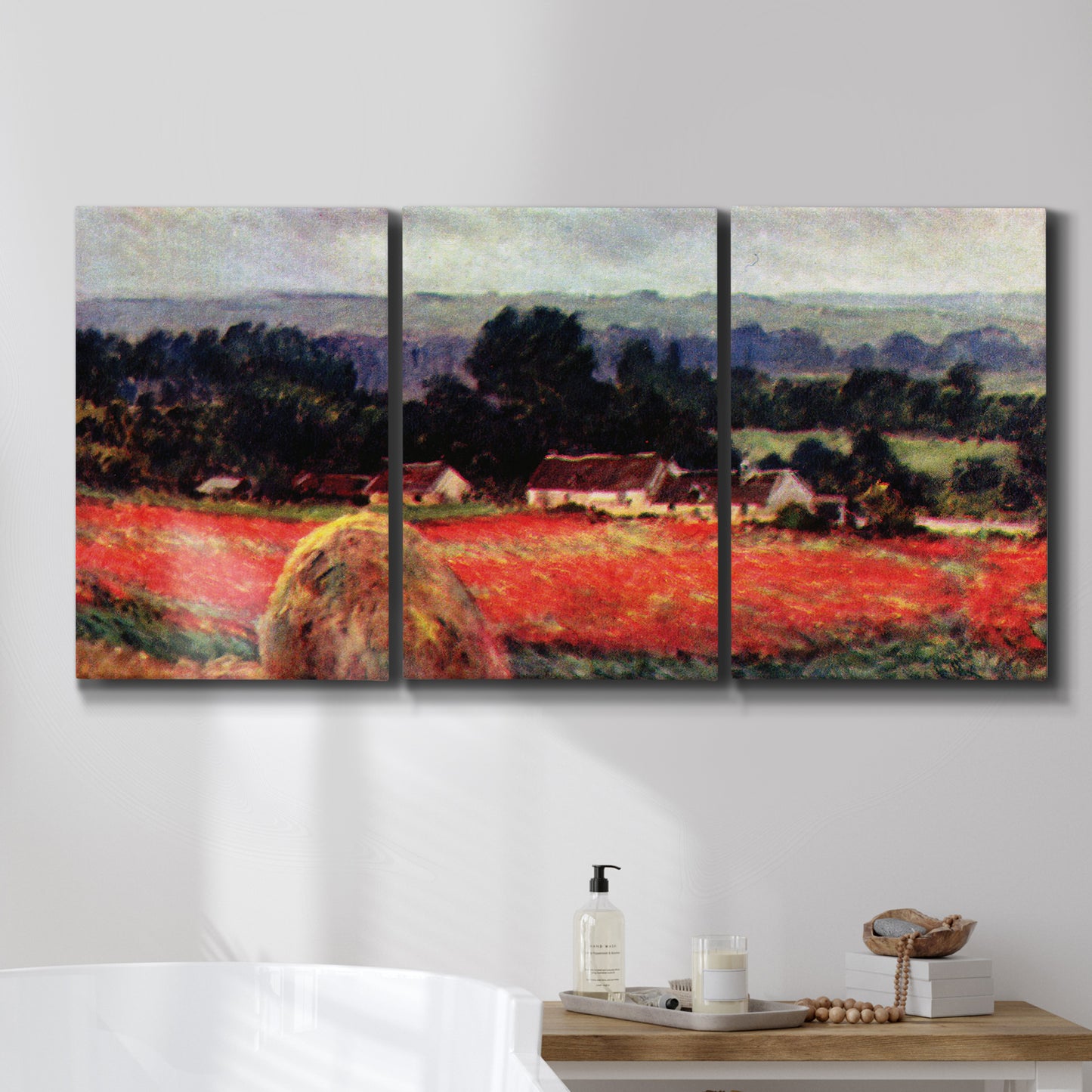 Three-panel canvas wall art featuring red poppy field near barn, displayed in a bathroom above a bathtub.