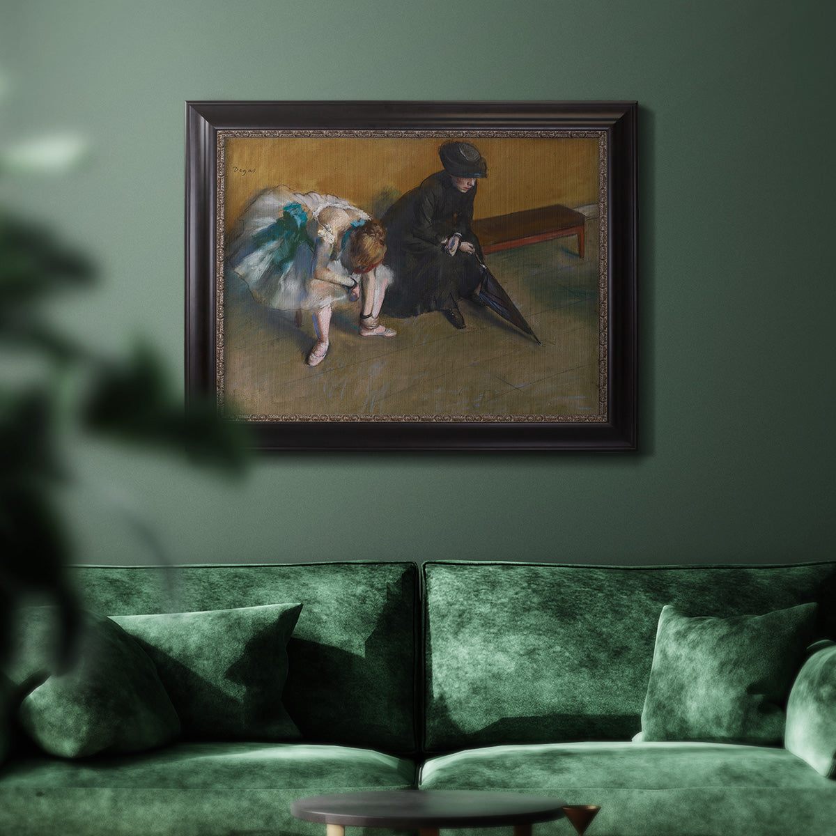 Impressionist portrait of a seated woman by Edgar Degas in an ornate black frame with gilded inner detail displayed in a dark-toned interior setting.