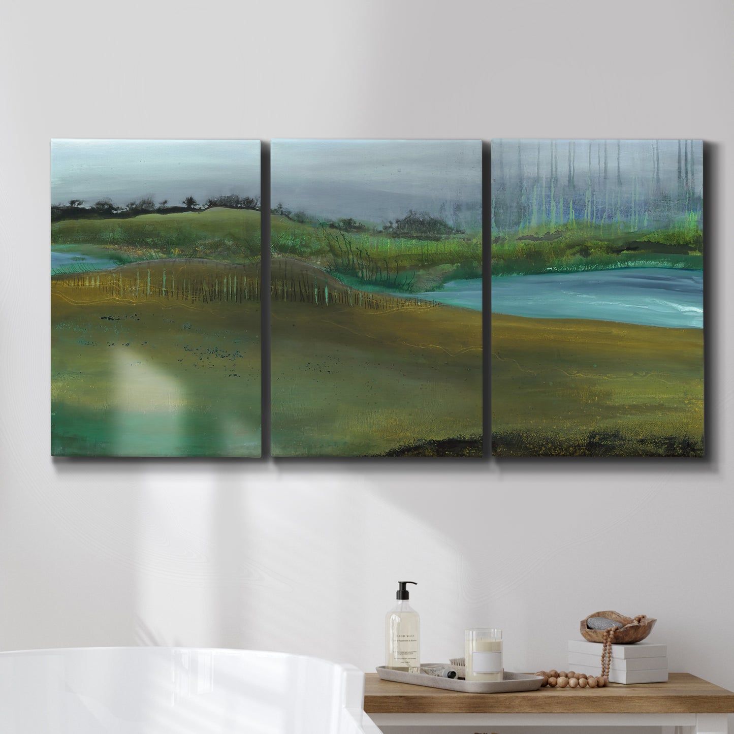 Three-panel canvas wall art featuring quiet contemplative landscape scene, displayed in a bathroom above a bathtub.
