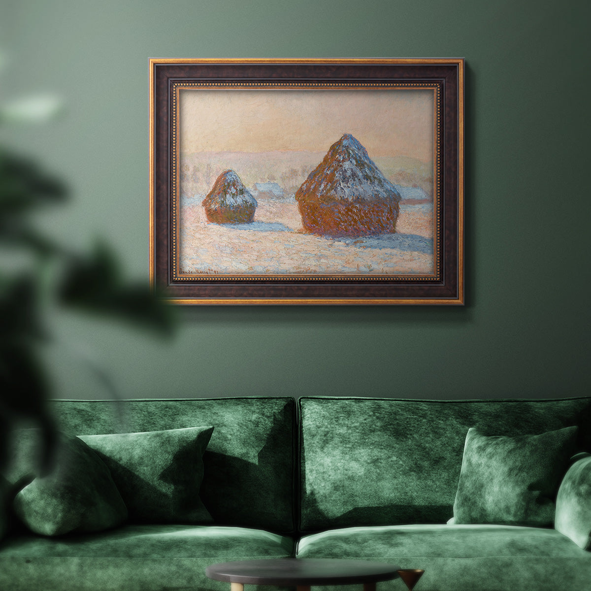 Impressionist winter haystack scene by Claude Monet in an ornate bronzed mahogany wood frame displayed in a dark-toned interior setting.