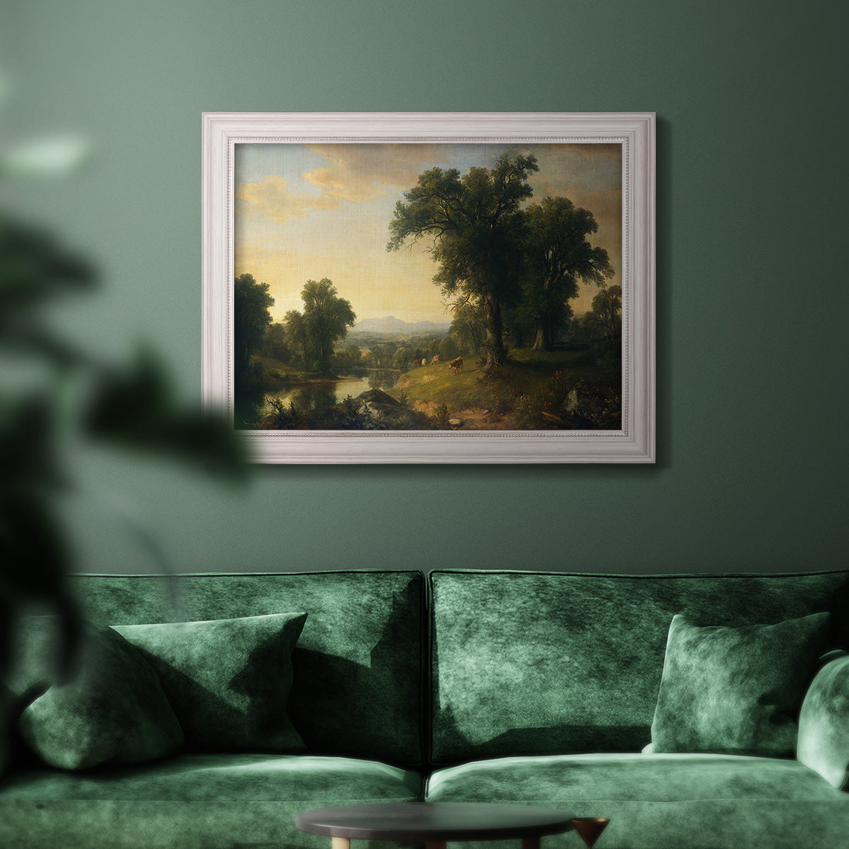 Traditional pastoral landscape painting by Asher Brown Durand in an ornate weathered white frame displayed in a dark-toned interior setting.