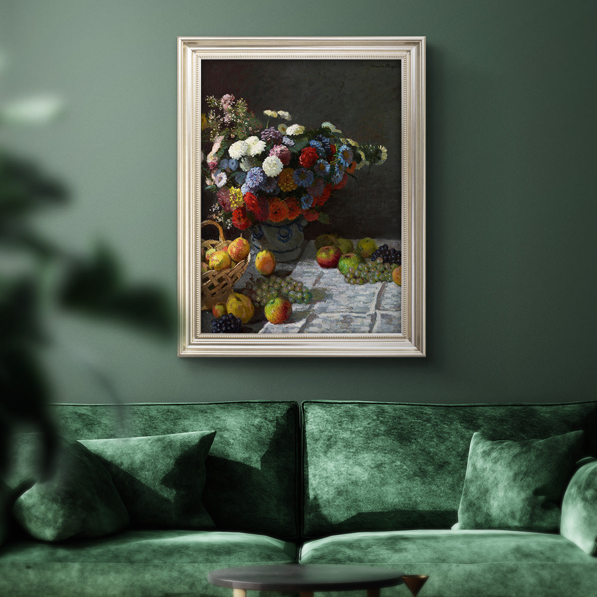 Impressionist floral still life painting by Claude Monet in an ornate champagne frame displayed in a dark-toned interior setting.