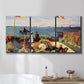 Three-panel canvas wall art featuring coastal garden overlooking sea, displayed in a bathroom above a bathtub.