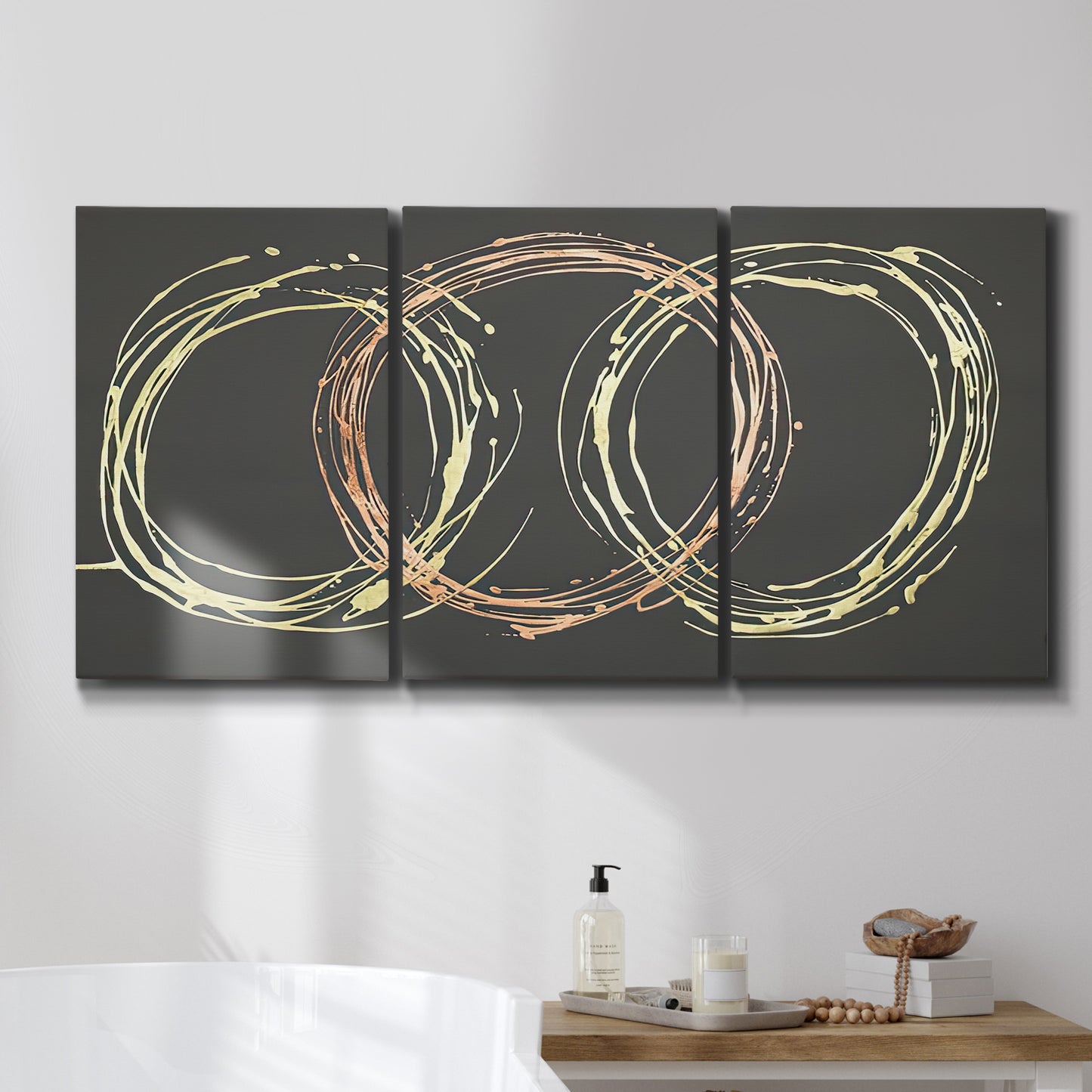 Three-panel canvas wall art featuring geometric abstract wave tangents, displayed in a bathroom above a bathtub.