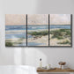 Three-panel canvas wall art featuring soft morning light over calm sea, displayed in a bathroom above a bathtub.