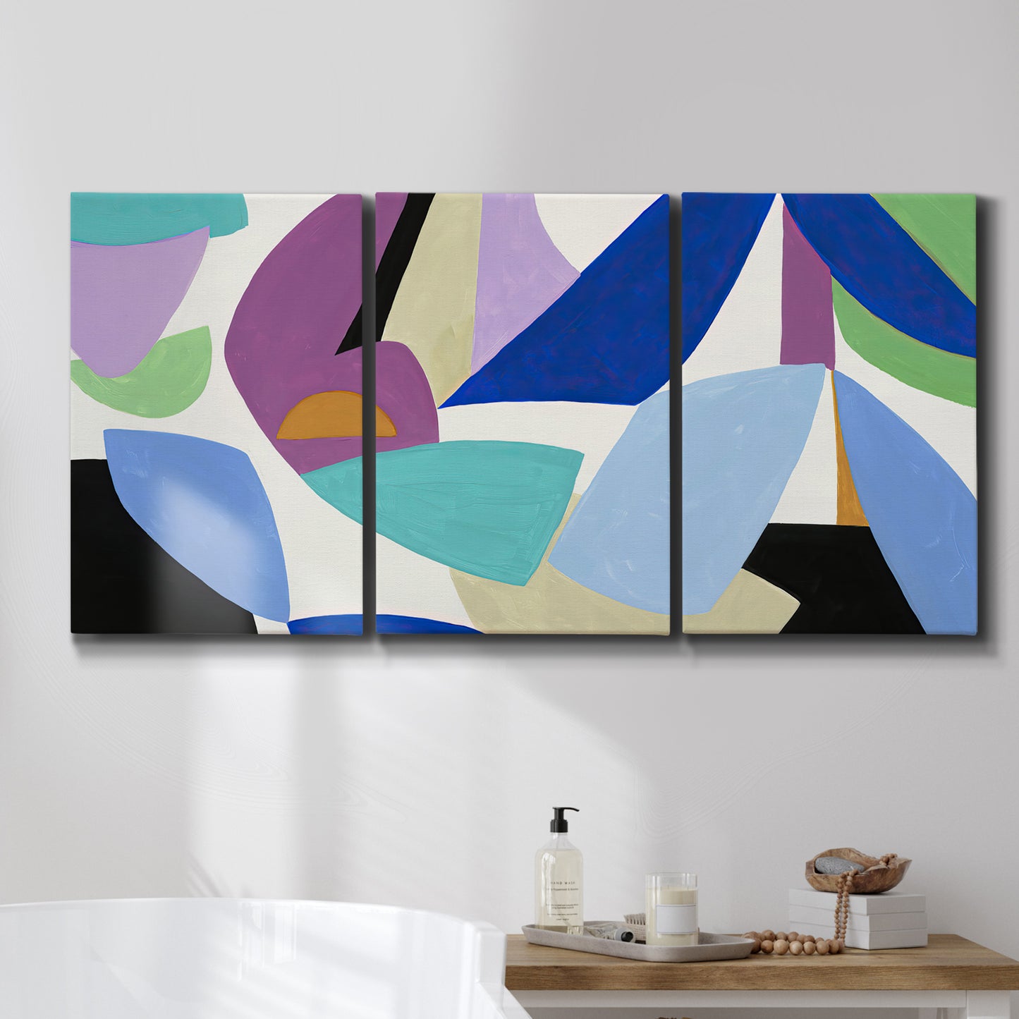 Three-panel canvas wall art featuring colorful abstract homage to modernism, displayed in a bathroom above a bathtub.