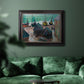 Impressionist coastal beach scene with boats by Claude Monet in an ornate black frame with gilded inner detail displayed in a dark-toned interior setting.