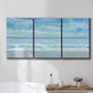 Three-panel canvas wall art featuring rolling ocean surf along shoreline, displayed in a bathroom above a bathtub.