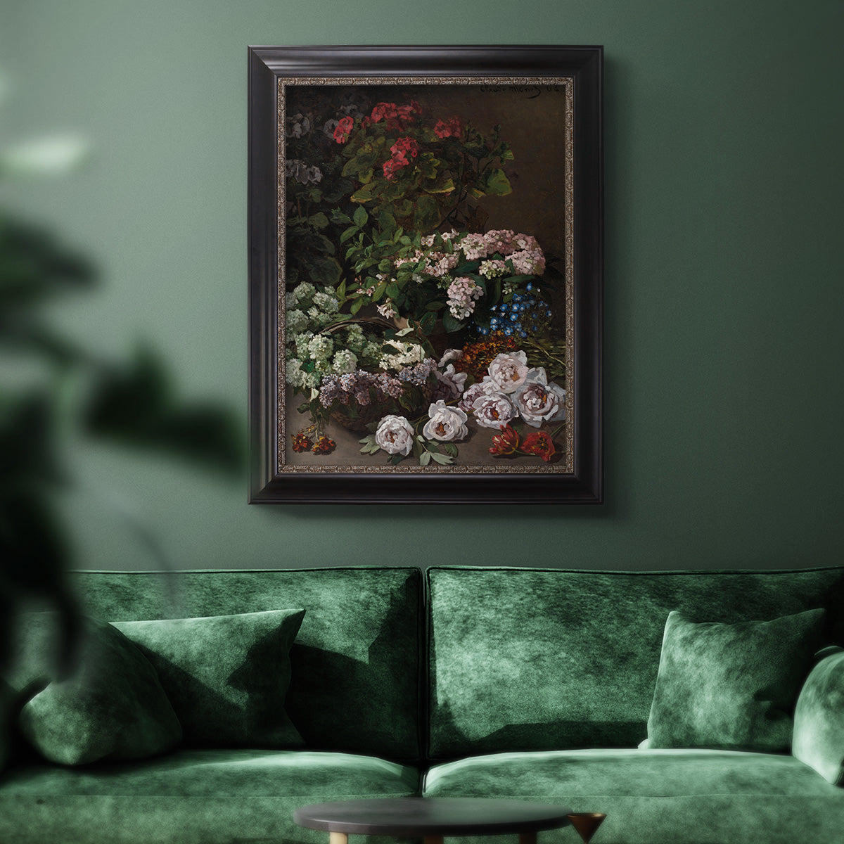 Early impressionist floral painting by Claude Monet in an ornate black frame with gilded inner detail displayed in a dark-toned interior setting.