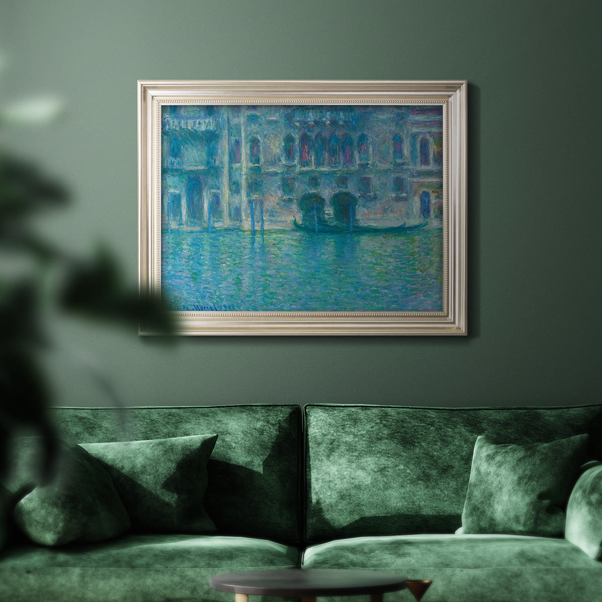 Impressionist Venetian palace waterfront scene by Claude Monet in an ornate champagne frame displayed in a dark-toned interior setting.