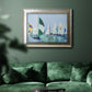 Coastal harbor watercolor painting in an ornate mottled silver frame displayed in a dark-toned interior setting.