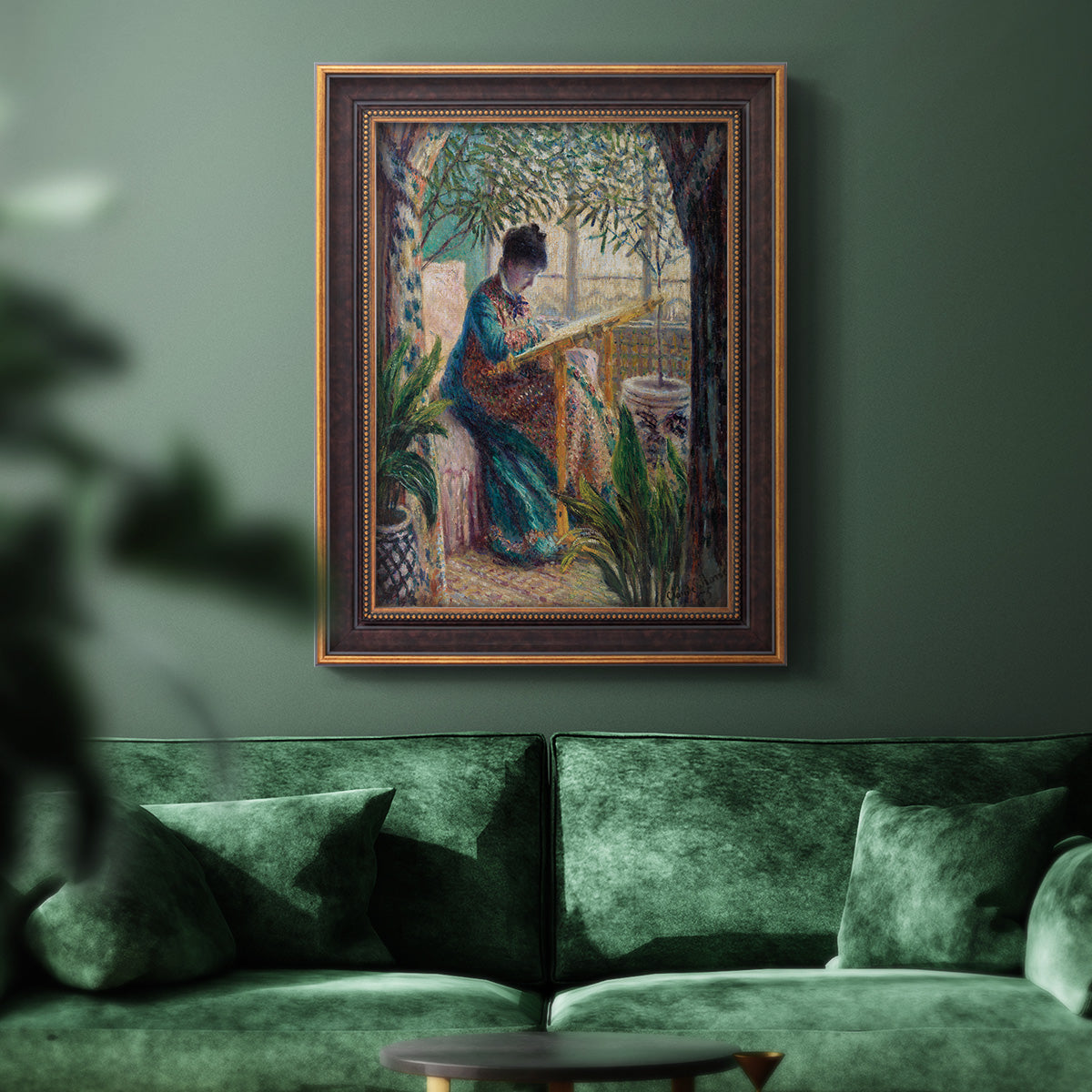 Impressionist portrait of Madame Monet sewing by Claude Monet in an ornate bronzed mahogany wood frame displayed in a dark-toned interior setting.