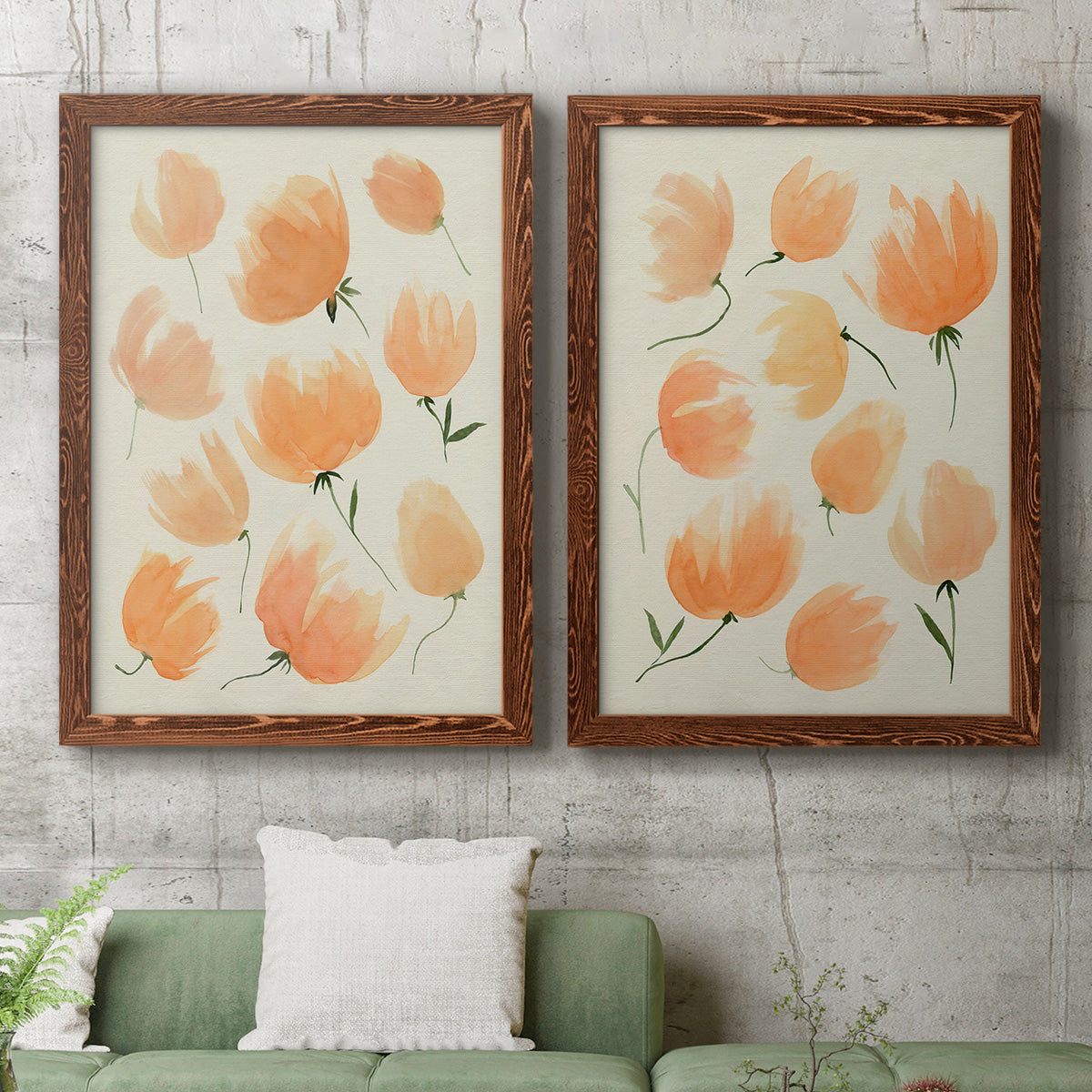 Set of two maple barnwood framed canvas prints depicting a coordinated art pair of loose peach-orange tulip-like blossoms rendered as airy watercolor floral paintings above a sofa in a modern living room.