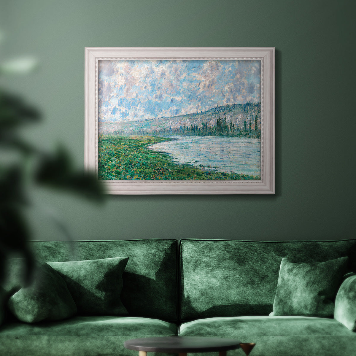 Impressionist river landscape at Vétheuil by Claude Monet in an ornate weathered white frame displayed in a dark-toned interior setting.