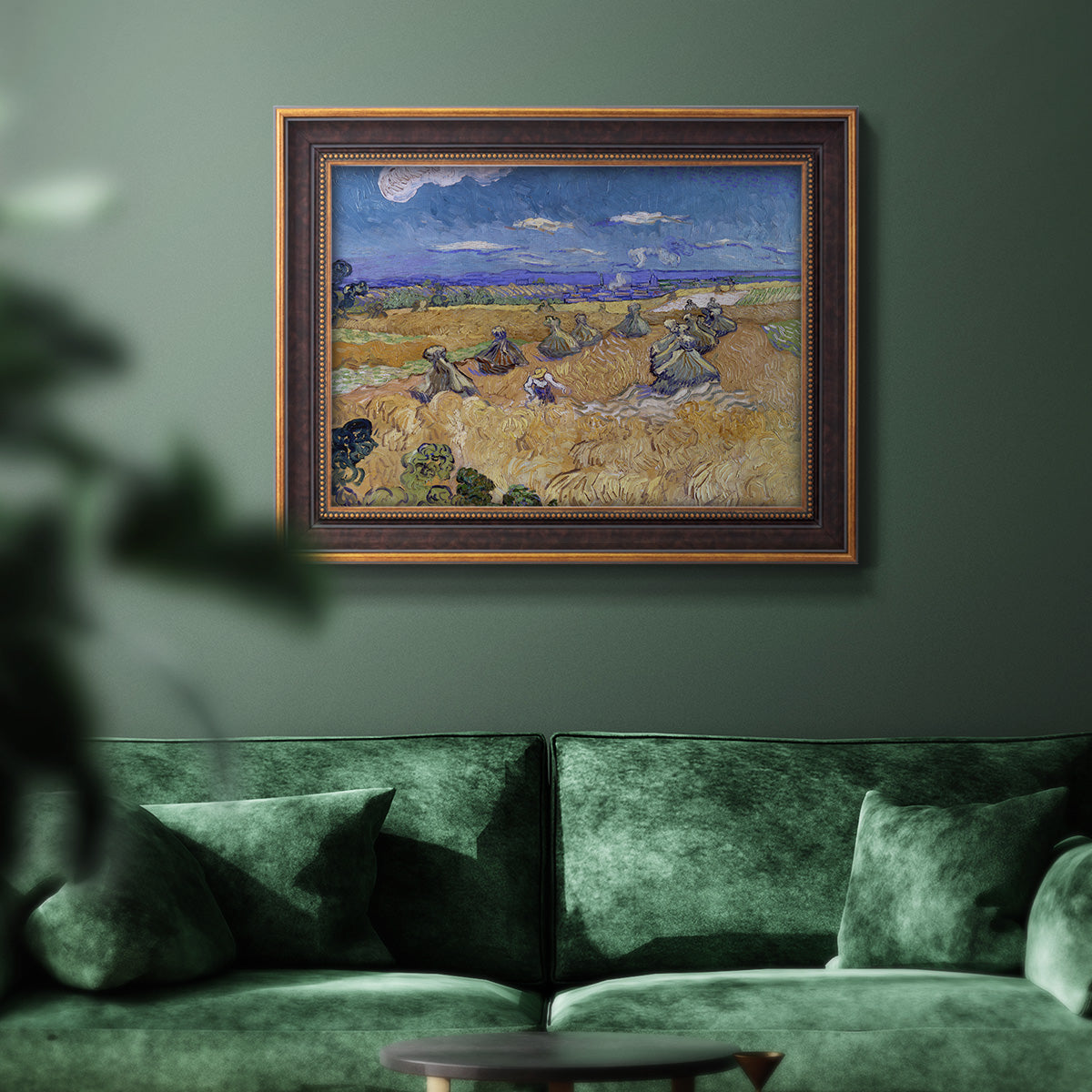Impressionist wheat harvest scene by Vincent van Gogh in an ornate bronzed mahogany wood frame displayed in a dark-toned interior setting.