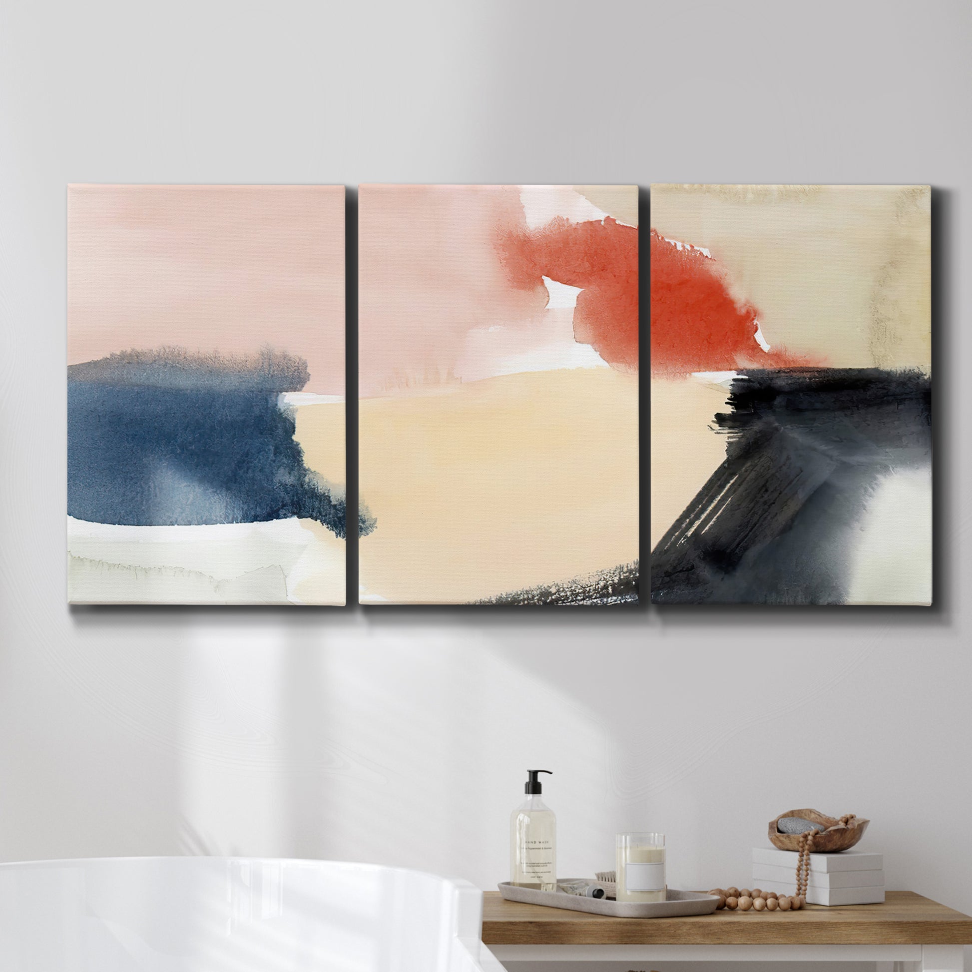 Three-panel canvas wall art featuring playful abstract watercolor shapes, displayed in a bathroom above a bathtub.