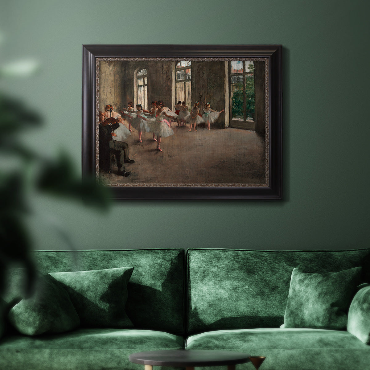Early impressionist ballet rehearsal painting by Edgar Degas in an ornate black frame with gilded inner detail displayed in a dark-toned interior setting.