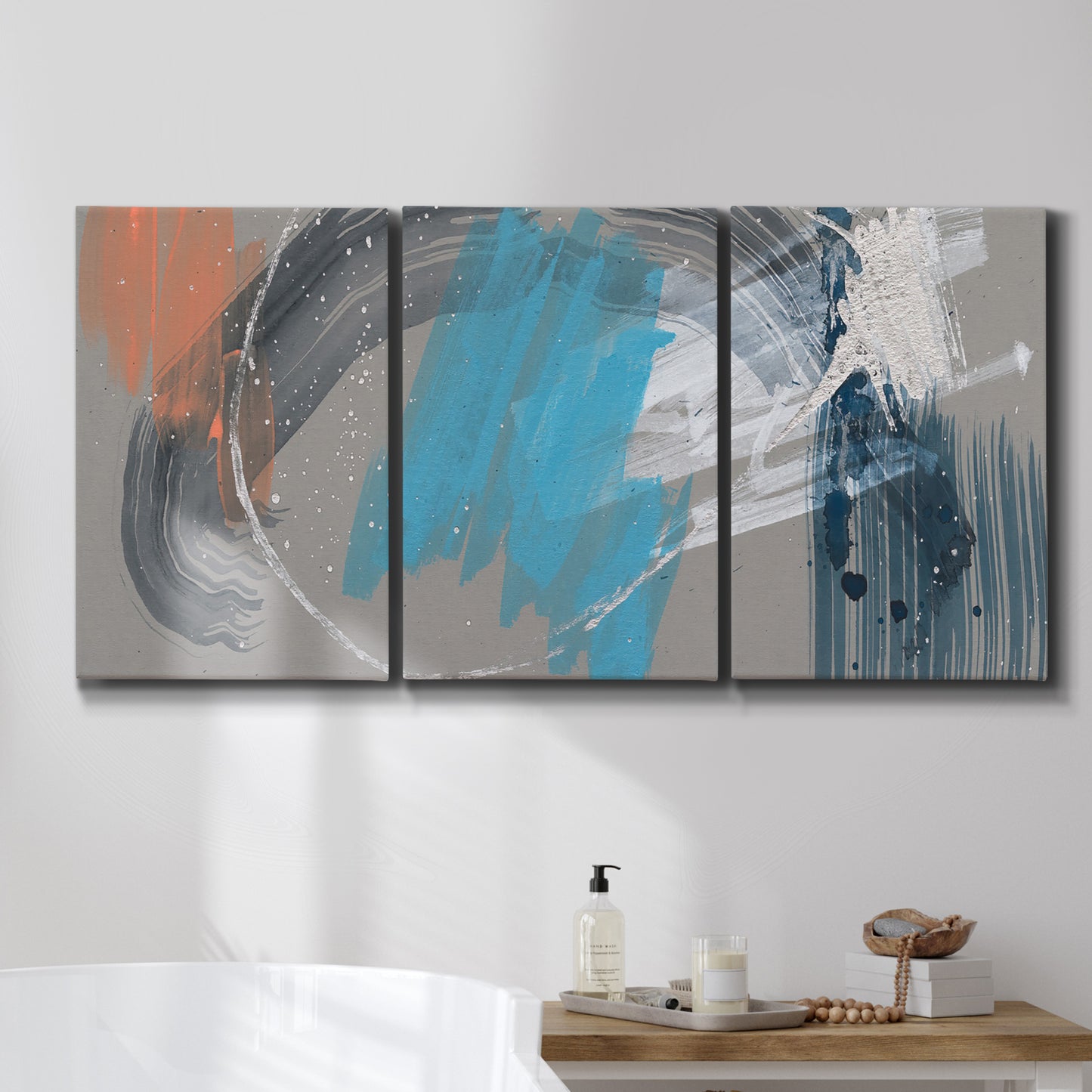Three-panel canvas wall art featuring playful abstract mark making, displayed in a bathroom above a bathtub.