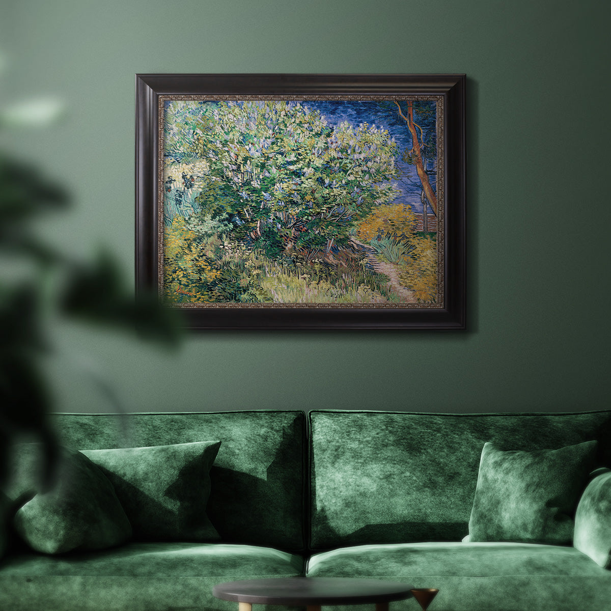 Impressionist lilac flower painting by Vincent van Gogh in an ornate black frame with gilded inner detail displayed in a dark-toned interior setting.