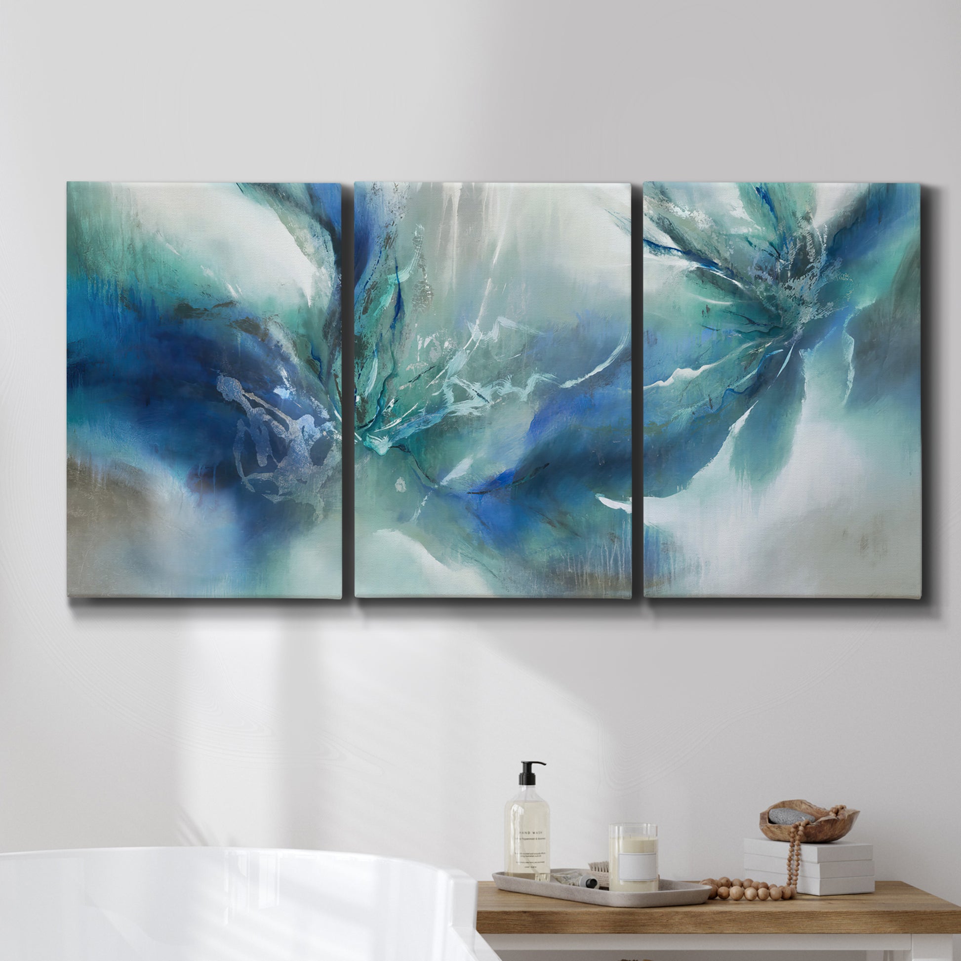 Three-panel canvas wall art featuring subtle abstract light flicker composition, displayed in a bathroom above a bathtub.