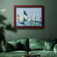 Coastal harbor watercolor painting in an ornate cherry burl wood frame displayed in a dark-toned interior setting.