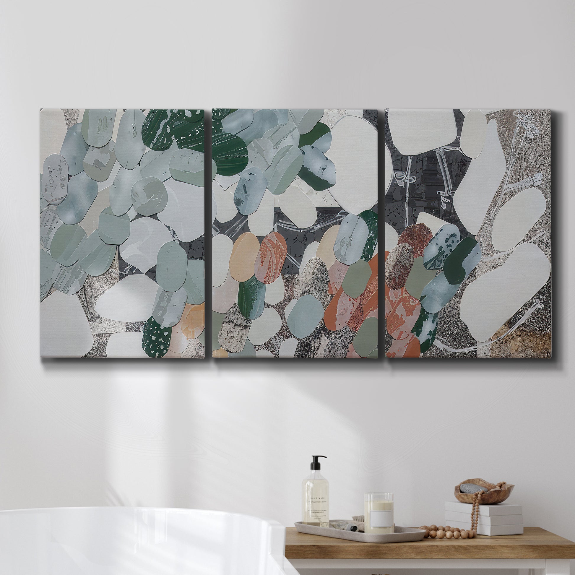Three-panel canvas wall art featuring layered canyon inspired abstract forms, displayed in a bathroom above a bathtub.
