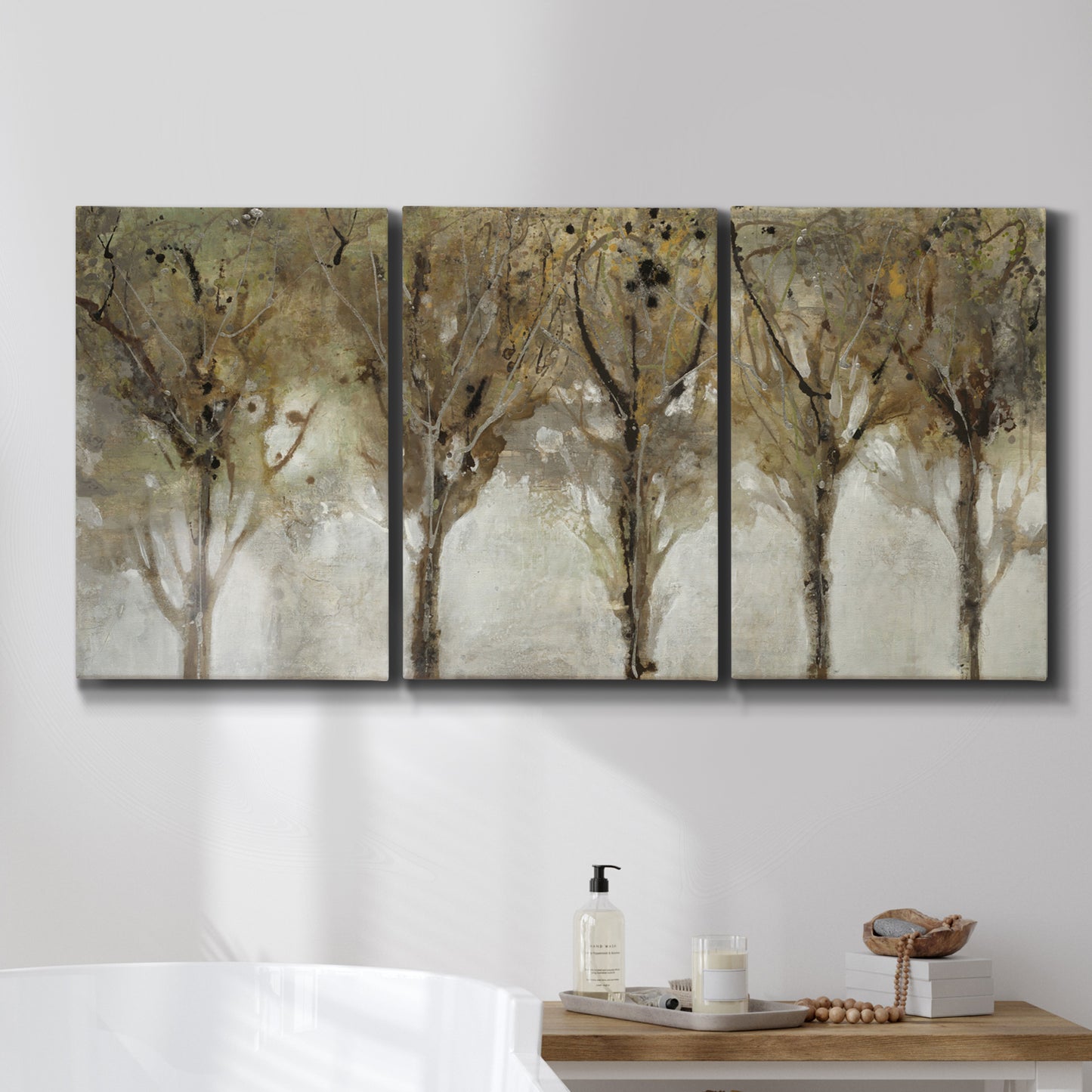 Three-panel canvas wall art featuring sunlight filtering through trees, displayed in a bathroom above a bathtub.