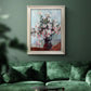 Impressionist chrysanthemum floral painting by Claude Monet in an ornate champagne frame displayed in a dark-toned interior setting.