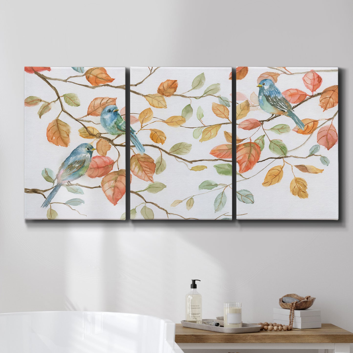 Three-panel canvas wall art featuring decorative bird trio illustration, displayed in a bathroom above a bathtub.