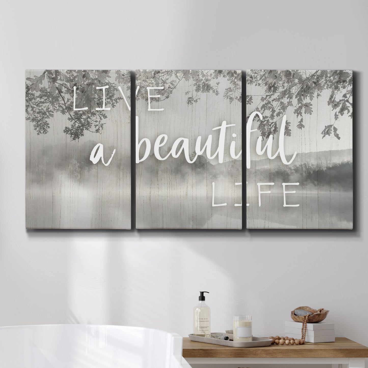 Three-panel canvas wall art featuring uplifting life themed typography, displayed in a bathroom above a bathtub.