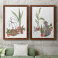 Set of two maple barnwood framed canvas prints depicting a coordinated art pair of cats tucked among collections of potted houseplants rendered as whimsical botanical animal illustrations above a sofa in a modern living room.