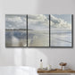 Three-panel canvas wall art featuring endless beach meeting ocean horizon, displayed in a bathroom above a bathtub.
