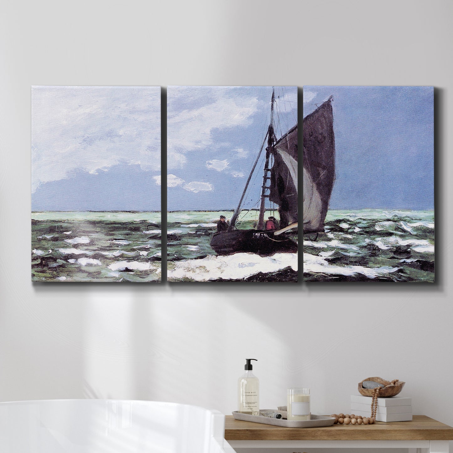 Three-panel canvas wall art featuring stormy sea with crashing waves, displayed in a bathroom above a bathtub.