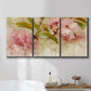 Three-panel canvas wall art featuring soft floral blossom composition, displayed in a bathroom above a bathtub.