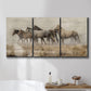 Three-panel canvas wall art featuring wild horses roaming open terrain, displayed in a bathroom above a bathtub.