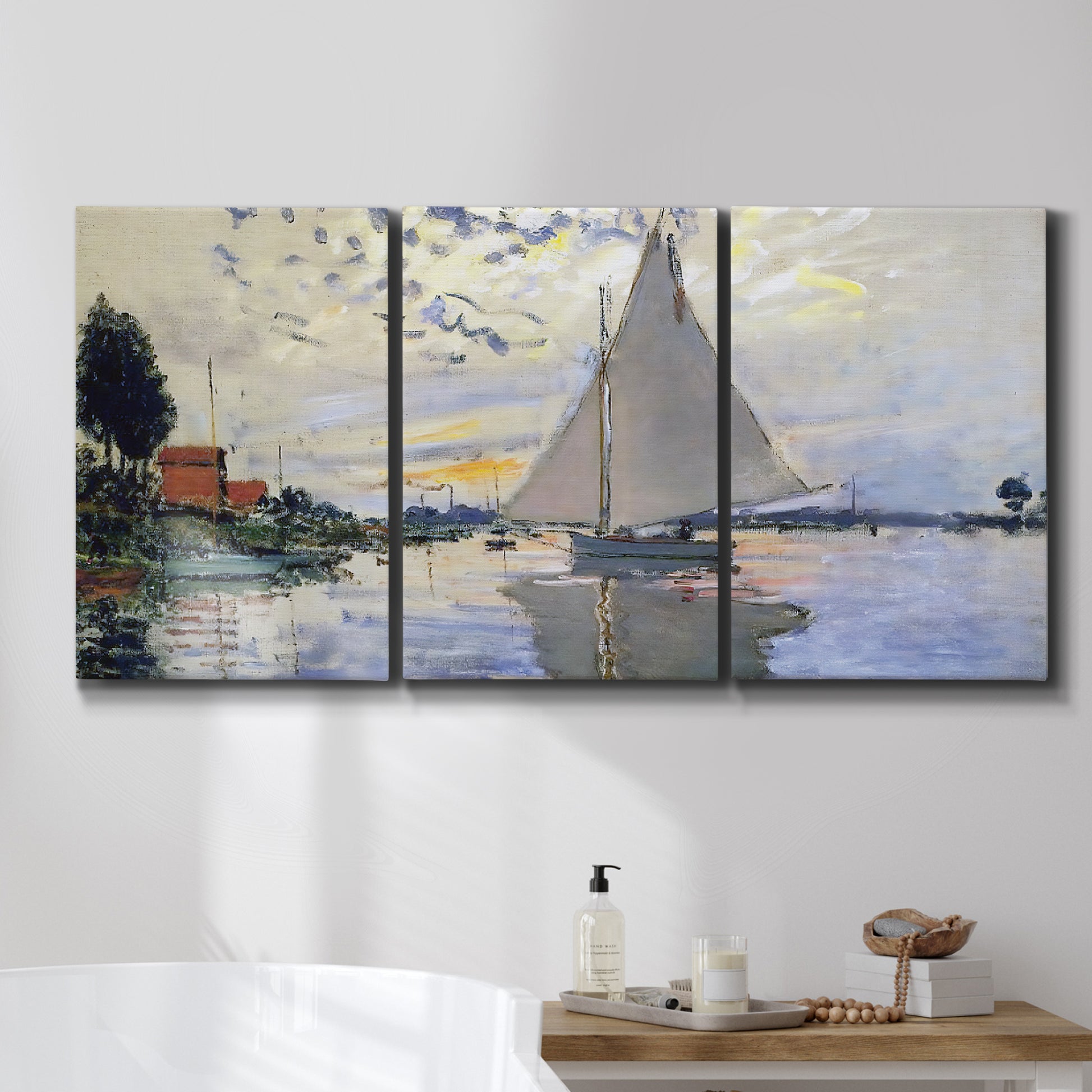 Three-panel canvas wall art featuring riverside village shoreline, displayed in a bathroom above a bathtub.