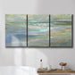 Three-panel canvas wall art featuring soft coastal beach light landscape, displayed in a bathroom above a bathtub.