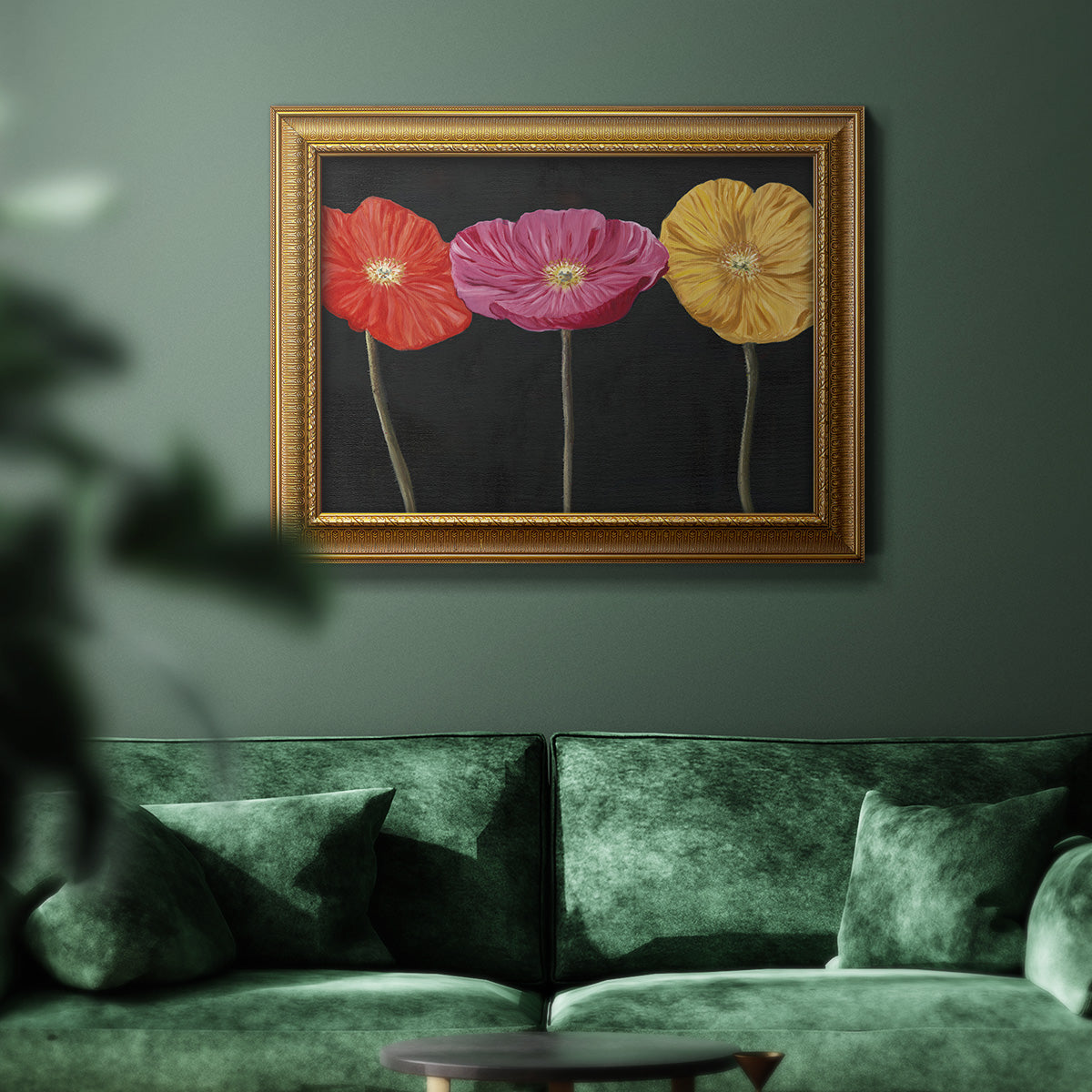 Contemporary poppy flower artwork in an ornate traditional gold frame displayed in a dark-toned interior setting.